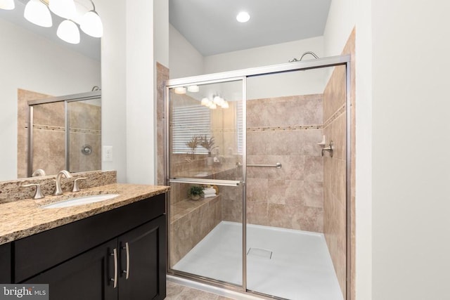 bathroom featuring a shower stall and vanity