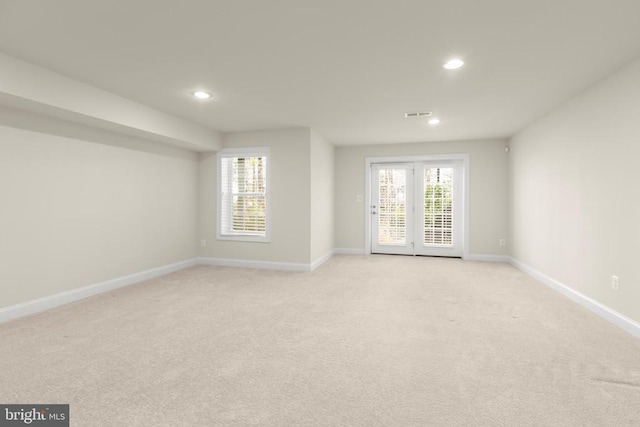 spare room with baseboards, light colored carpet, and recessed lighting