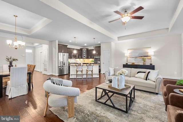 living area with a raised ceiling, baseboards, and dark wood-style flooring