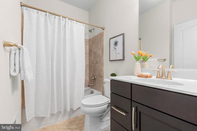 bathroom featuring vanity, tile patterned flooring, shower / bath combo with shower curtain, and toilet