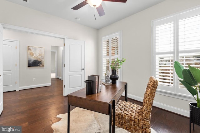 home office with a ceiling fan, baseboards, and hardwood / wood-style floors