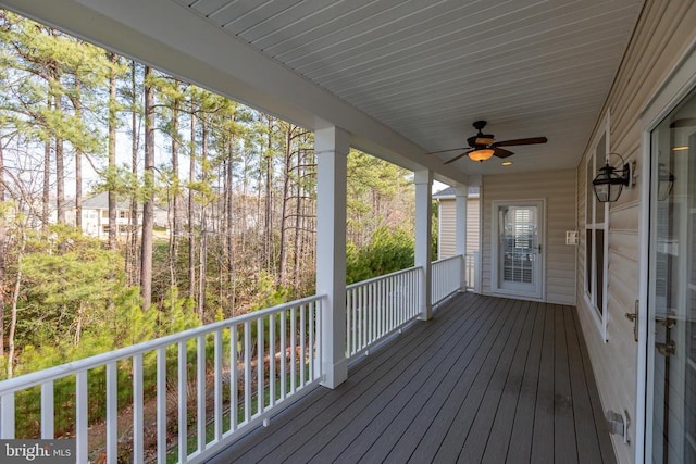 wooden deck featuring ceiling fan