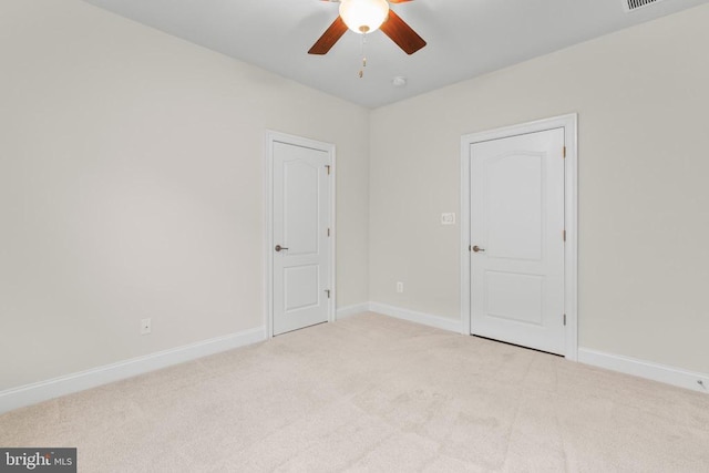 spare room with ceiling fan, carpet, and baseboards