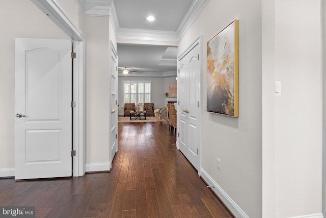 hall featuring dark wood-style floors, ornamental molding, recessed lighting, and baseboards