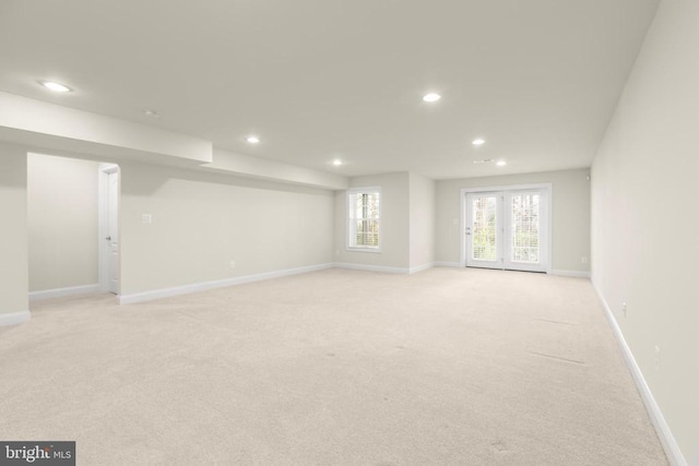 interior space featuring baseboards, french doors, light carpet, and recessed lighting