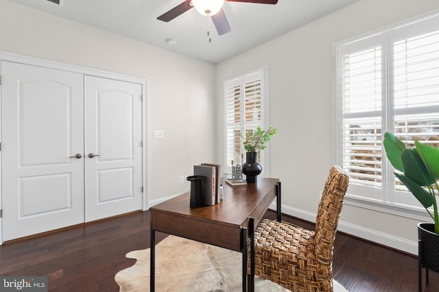 office area featuring dark wood-type flooring, baseboards, and a ceiling fan