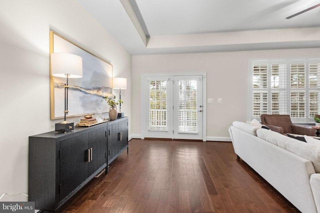 doorway with dark wood-style flooring and baseboards