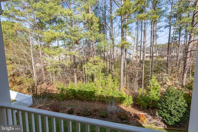 view of yard with fence and a view of trees