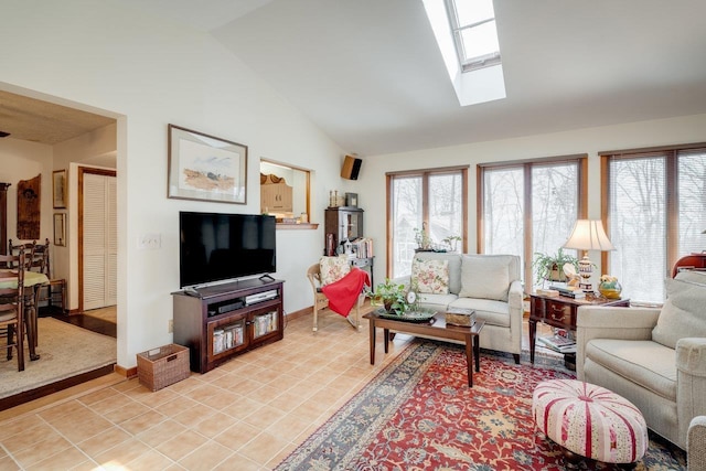 living area featuring light tile patterned floors, baseboards, and lofted ceiling with skylight