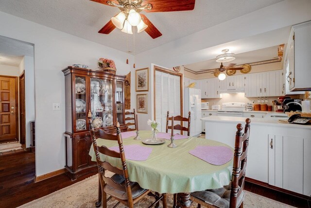 dining area with ceiling fan, baseboards, and wood finished floors
