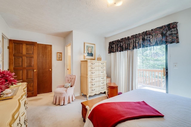 bedroom with light colored carpet, a textured ceiling, and access to outside