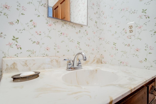 bathroom with vanity and wallpapered walls