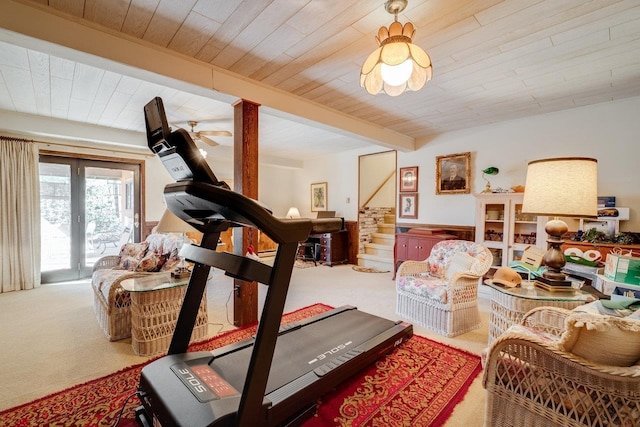 exercise room featuring carpet flooring and wooden ceiling
