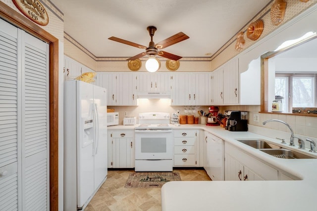 kitchen featuring a ceiling fan, under cabinet range hood, white appliances, a sink, and light countertops