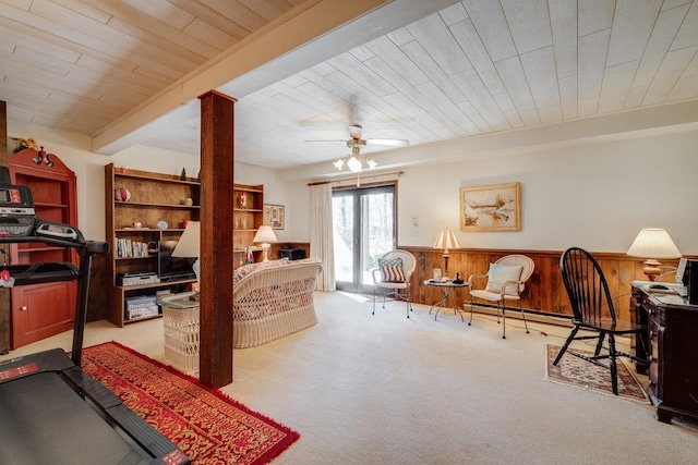 interior space with a baseboard radiator, wainscoting, ceiling fan, and carpet floors