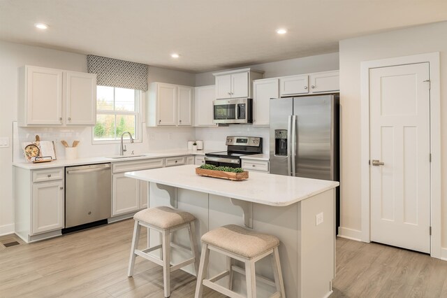108 Courtyard Ter, New Market, VA 22844 - kitchen featuring appliances with stainless steel finishes, light wood-type flooring, a kitchen breakfast bar, a kitchen island, and recessed lighting