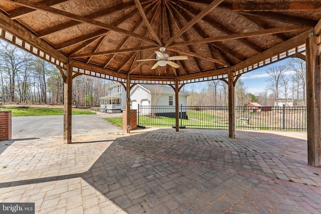 view of patio with a gazebo, fence, and a ceiling fan