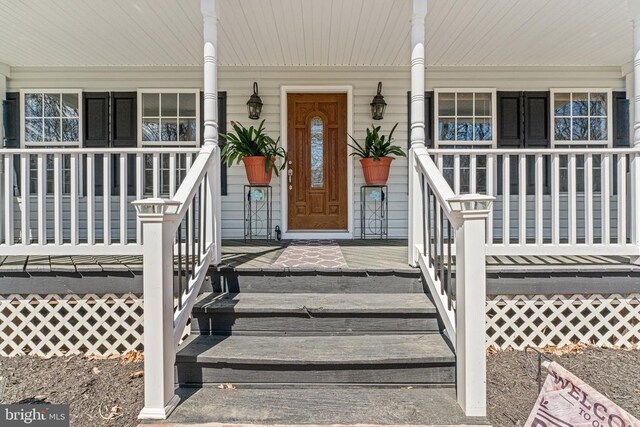 view of exterior entry with a porch
