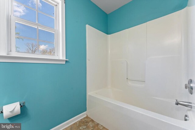 full bathroom with baseboards and bathtub / shower combination
