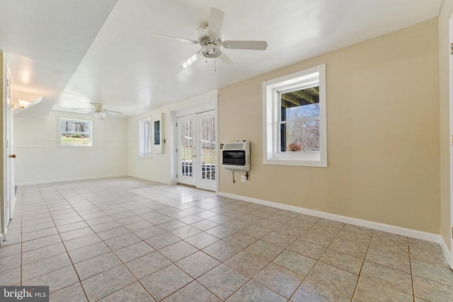 unfurnished living room with heating unit, ceiling fan, light tile patterned flooring, and french doors