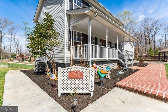 view of property exterior with a porch and central AC