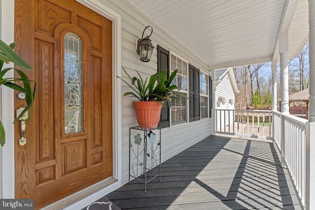 wooden terrace featuring covered porch