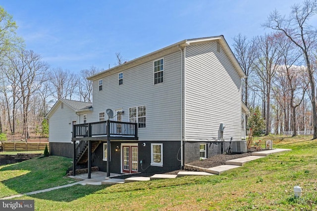 back of property with a deck, central air condition unit, stairs, and a yard