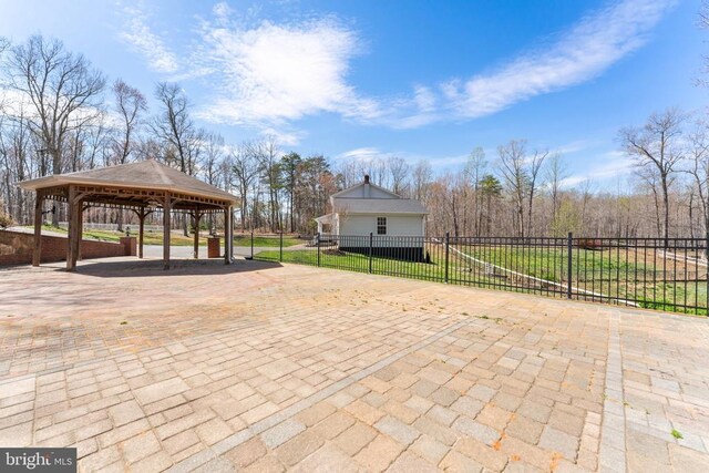 view of patio / terrace featuring a gazebo, a detached carport, and decorative driveway
