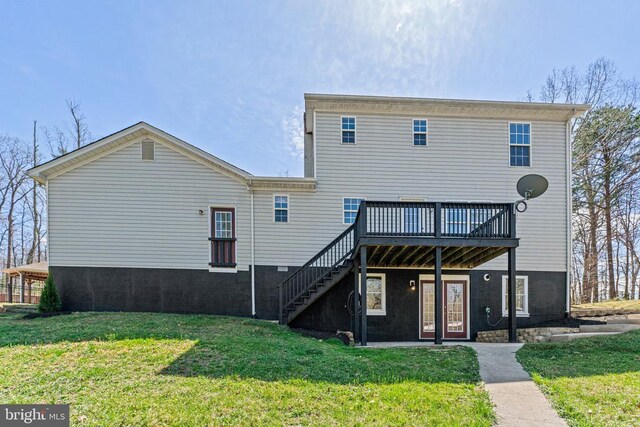 rear view of property with a deck, stairs, and a lawn