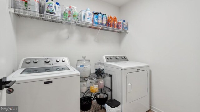clothes washing area featuring washer and dryer
