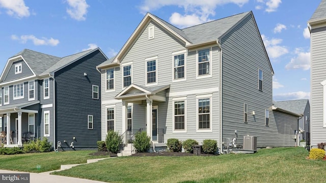 view of front of home featuring a front lawn and central AC unit