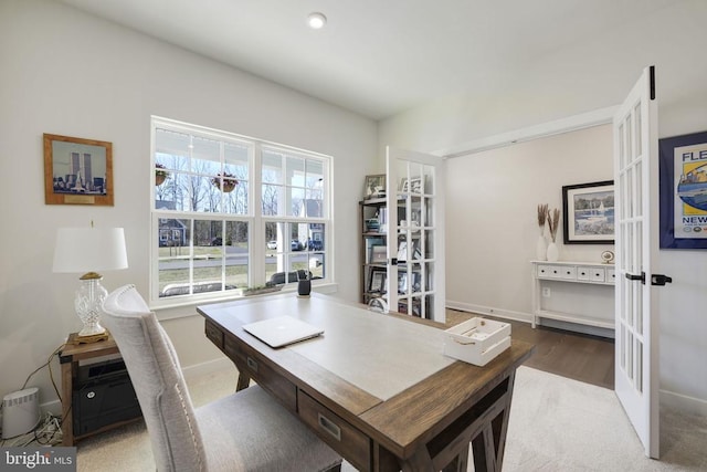 office space featuring wood finished floors, french doors, and baseboards