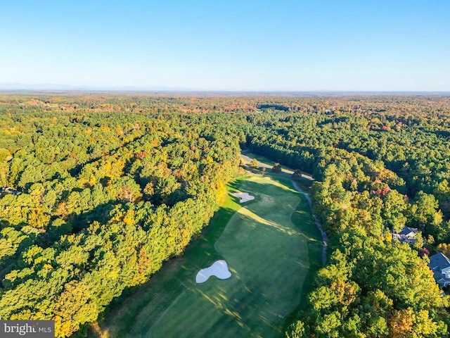 birds eye view of property featuring golf course view and a view of trees