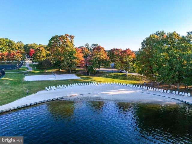 view of community featuring a lawn and a water view