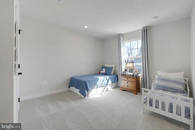 carpeted bedroom featuring baseboards and recessed lighting