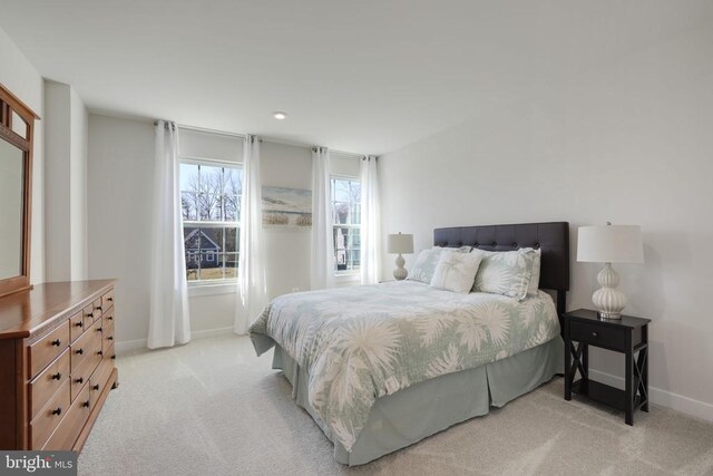 bedroom with baseboards, recessed lighting, and light colored carpet