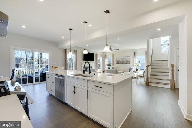 kitchen featuring a sink, dishwasher, white cabinetry, open floor plan, and dark wood-style floors