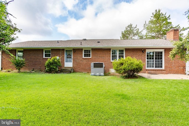 307 Butternut Dr, Fredericksburg, VA 22408 - rear view of house featuring entry steps, a yard, a chimney, and a patio area