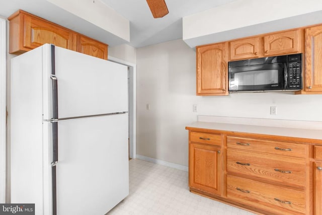 307 Butternut Dr, Fredericksburg, VA 22408 - kitchen with freestanding refrigerator, black microwave, light flooring, light countertops, and a ceiling fan