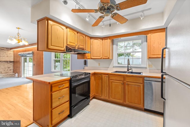 307 Butternut Dr, Fredericksburg, VA 22408 - kitchen with track lighting, freestanding refrigerator, black range with electric cooktop, a peninsula, and dishwasher