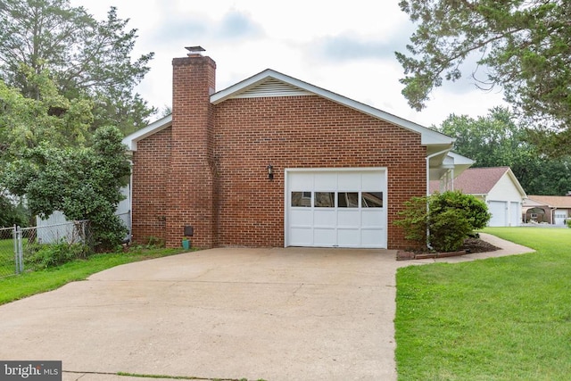 307 Butternut Dr, Fredericksburg, VA 22408 - view of home's exterior featuring a chimney, an attached garage, concrete driveway, and brick siding