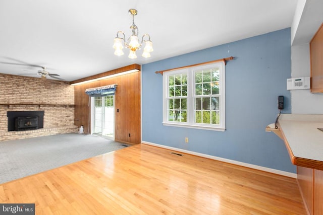 307 Butternut Dr, Fredericksburg, VA 22408 - unfurnished living room with healthy amount of natural light, wood finished floors, a ceiling fan, and a chandelier