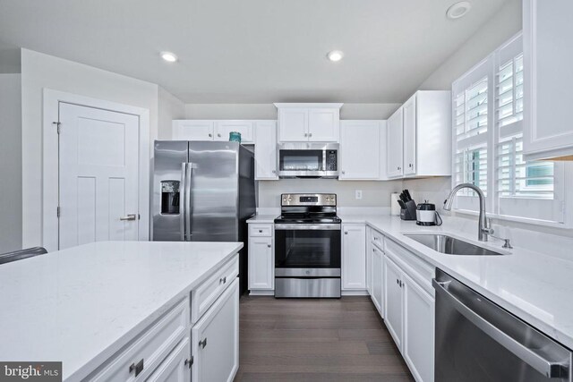 8859 Marlow Dr, Spotsylvania, VA 22551 - kitchen featuring appliances with stainless steel finishes, white cabinets, dark wood-type flooring, recessed lighting, and light stone countertops