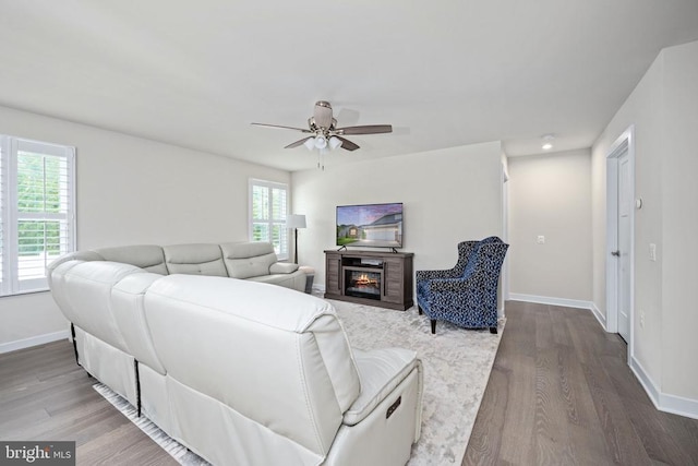 8859 Marlow Dr, Spotsylvania, VA 22551 - living area with wood finished floors, ceiling fan, and a glass covered fireplace