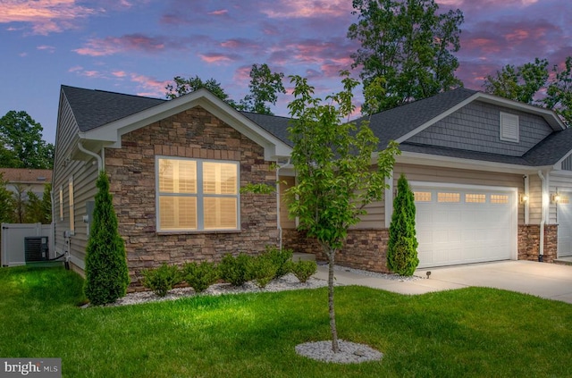 8859 Marlow Dr, Spotsylvania, VA 22551 - view of front of home with stone siding, a front lawn, concrete driveway, an attached garage, and a shingled roof