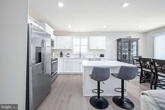 8859 Marlow Dr, Spotsylvania, VA 22551 - kitchen with stainless steel appliances, a kitchen bar, healthy amount of natural light, light countertops, and recessed lighting