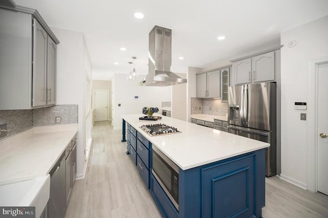 kitchen with island range hood, stainless steel appliances, baseboards, light wood-type flooring, and recessed lighting