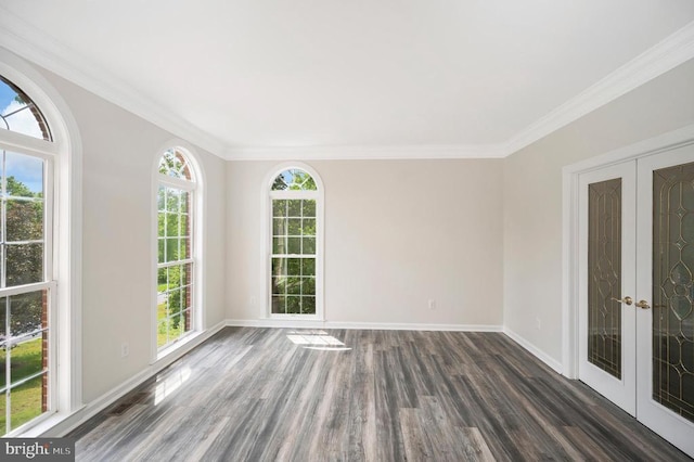 unfurnished room with plenty of natural light, crown molding, wood finished floors, and french doors