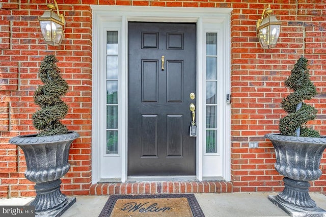 property entrance with brick siding