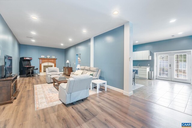 living room with recessed lighting, french doors, and wood finished floors